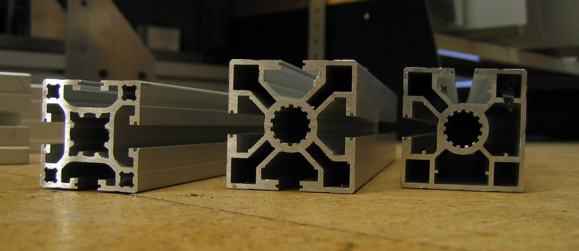 Photograph of three real extruded aluminium sections